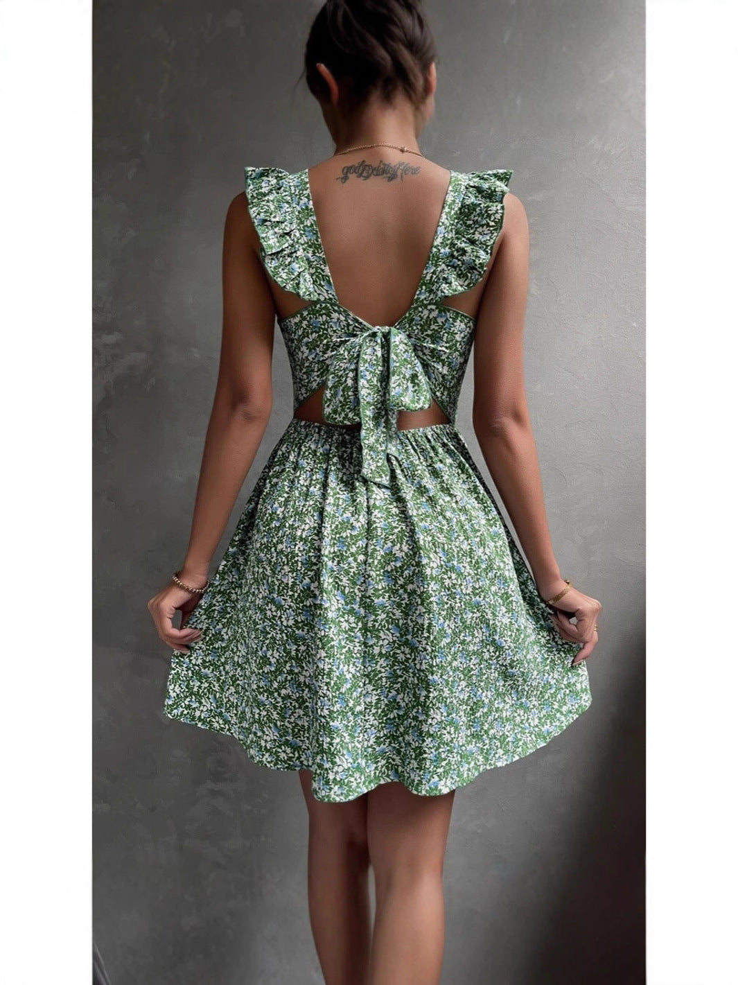 Close view of the ditsy floral print and ruffled shoulder straps on the mini dress