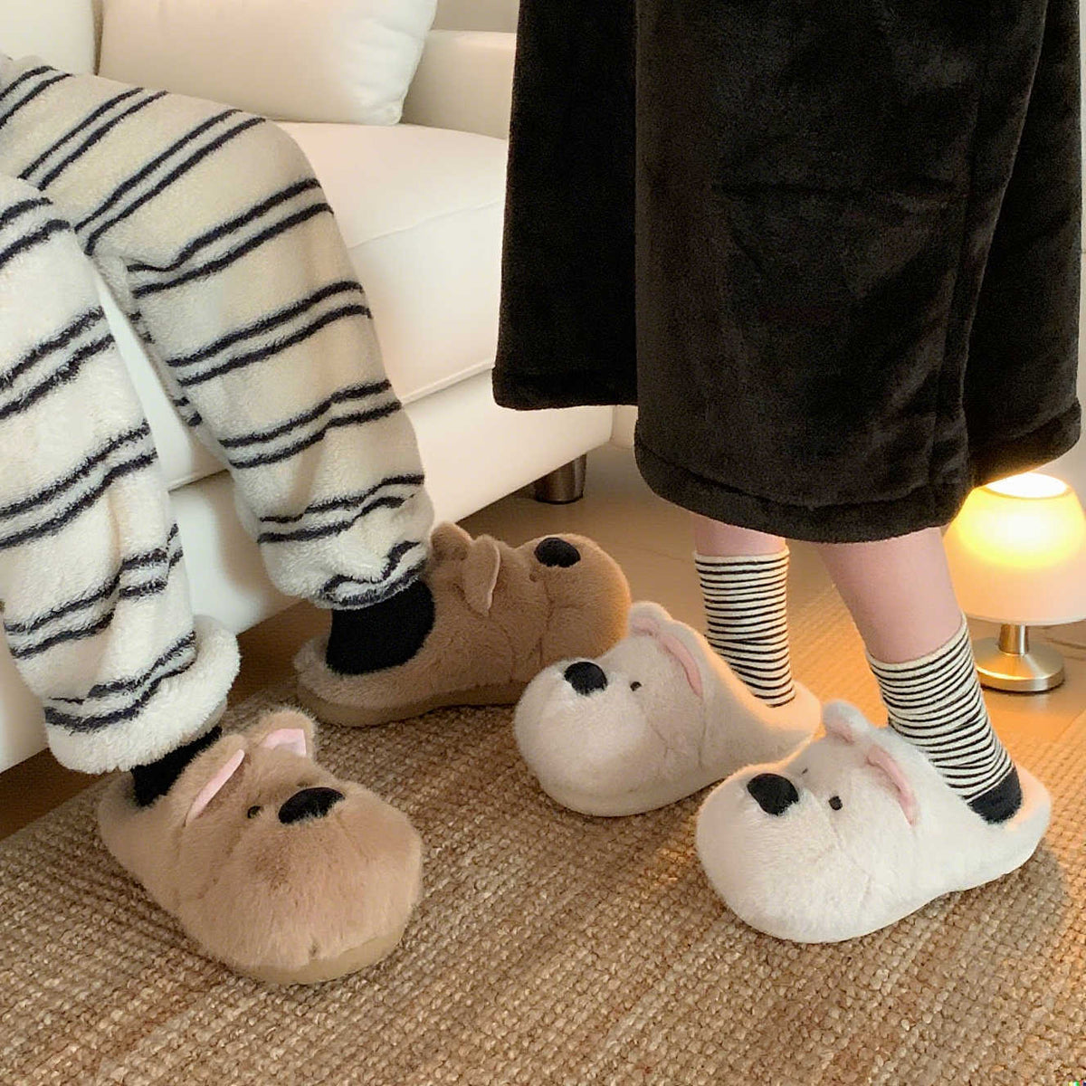 White puppy plush slippers beside a brown pair, worn with striped socks; only the white pair is offered