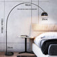 Remote control handset for the adjustable arc LED floor lamp on a pale surface