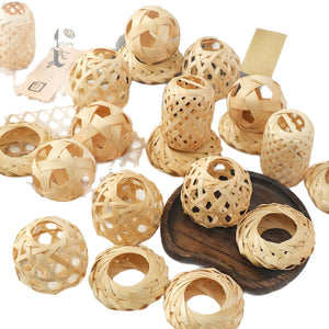 Assortment of handwoven bamboo ornaments, woven balls, rings and mini lantern shapes on white