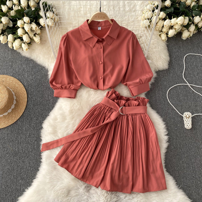 Shirt and skirt two-piece set laid out flat to show both garments