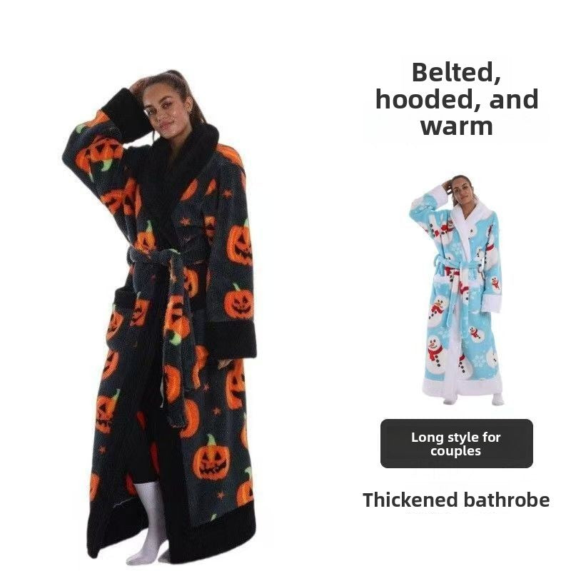 Woman in a long black pumpkin print fleece bathrobe with black plush notched collar, cuffs and hem