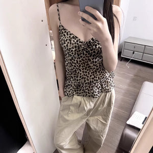 Leopard print camisole top with slim straps and a ruched V neckline styled with light trousers
