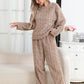 Woman in a khaki tan brown coral fleece pajama set with a cable-like jacquard texture, round neck and long sleeves