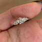 Close view of the sterling silver ring, faceted round cubic zirconia center with scattered accent stones on the shoulders