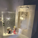 Christmas DIY LED night light with a lit street lamp and couple figurines inside a clear acrylic case