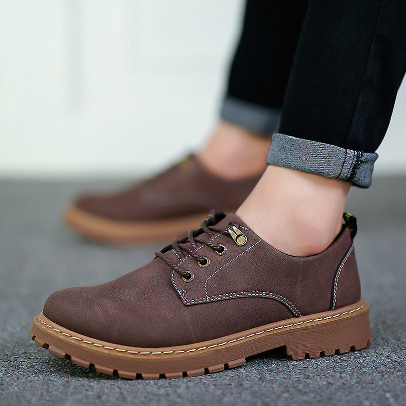 Brown low-top lace-up derby shoe with lugged rubber sole worn with rolled jeans, EU 39 option