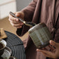 Ceramic storage jar holding coffee beans on a kitchen counter