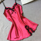 Rose red satin slip nightdress with black lace at the neckline and hem, flat on a gray cloth, option photo for size L