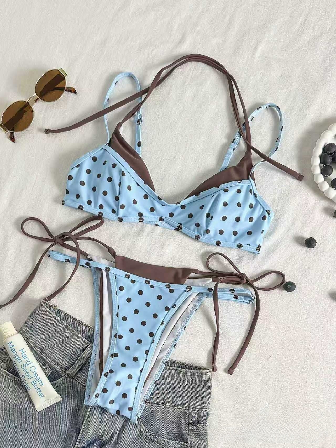 Red polka dot bikini flat lay with pink binding, triangle top above the tie side brief