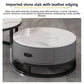 Close view of a white marble pattern stone top on a gray round drawer table under a leather edging heading