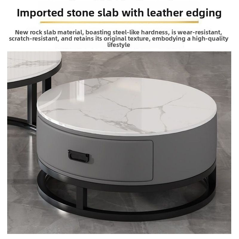 Close view of a white marble pattern stone top on a gray round drawer table under a leather edging heading