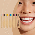 Eleven bamboo toothbrushes with colored bristles beside a smiling child