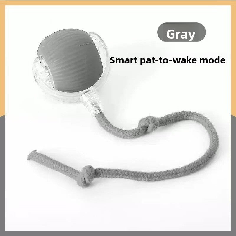 Grey silicone rolling cat ball with a knotted rope tail, labelled with the pat to wake mode