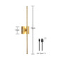Gold linear wall lamp on a hallway wall lit with a warm soft vertical light