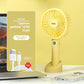 Mini USB handheld fan held for scale next to a hand, pocket size