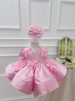 Pink satin princess dress shown with full round skirt