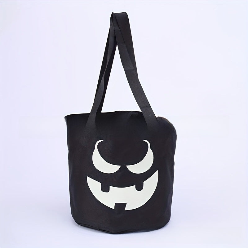 Colored canvas trick or treat bucket with a printed pumpkin face and carry handles
