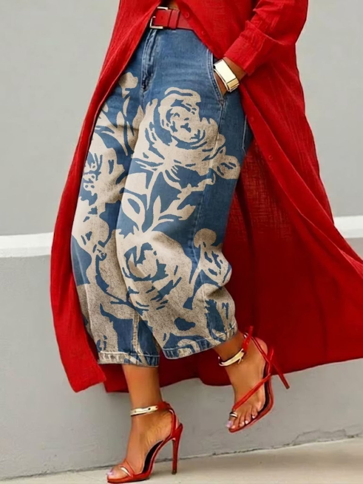 Wide leg cropped denim jeans with large cream rose print on blue denim, red coat and heels