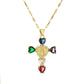 Cross pendant set with pink cubic zirconia hanging from a slim gold tone chain