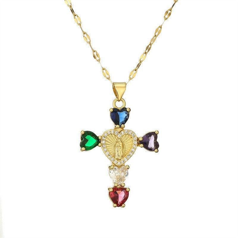 Cross pendant set with pink cubic zirconia hanging from a slim gold tone chain