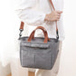 Top zip closure of the insulated lunch bag holding a stacked lunch container upright