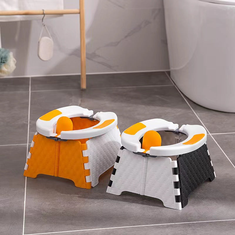 Orange and gray folding travel potties with padded oval seats set beside a bathtub on gray tile