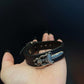 Black leather concho cuff bracelet photographed in soft natural daylight