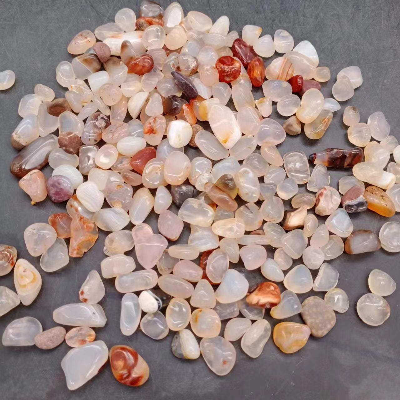 Larger tumbled agate stones in mixed colours for landscaping accents