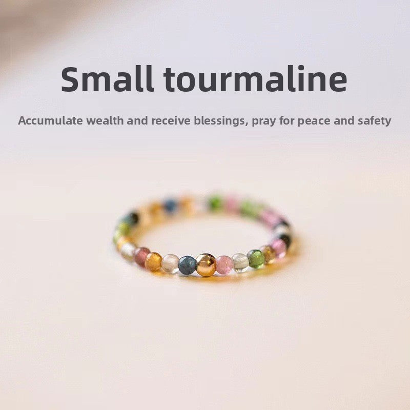 Close up of natural rainbow tourmaline beads strung on the elastic cord
