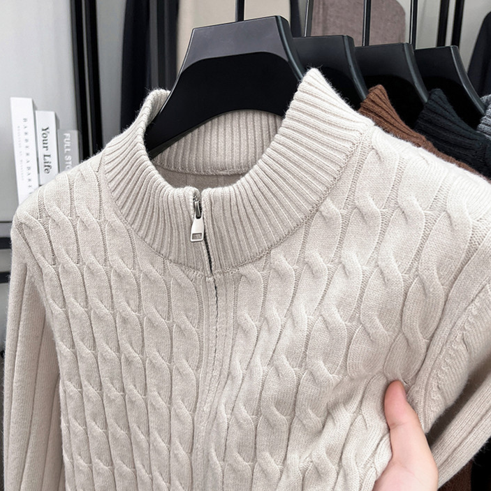 Cream thick cable knit half zip sweater with a stand collar and neck zip