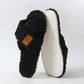 Black crossed plush open toe slipper standing beside its textured TPR sole, size 40-41 option