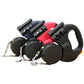 Blue, red and black dual retractable pet leashes lined up together on a plain white studio background