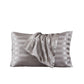 White satin pillowcase with a cool glossy finish on a bed