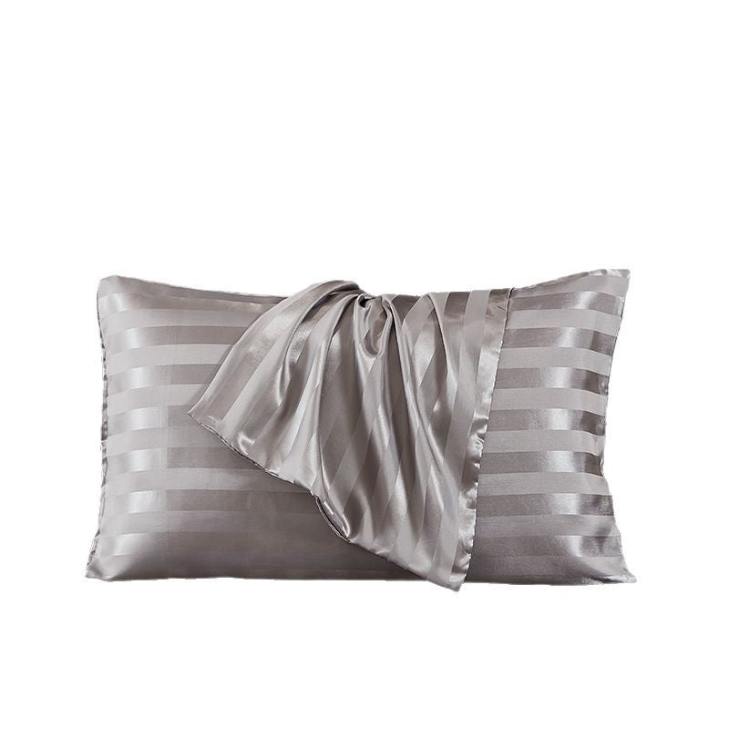 White satin pillowcase with a cool glossy finish on a bed