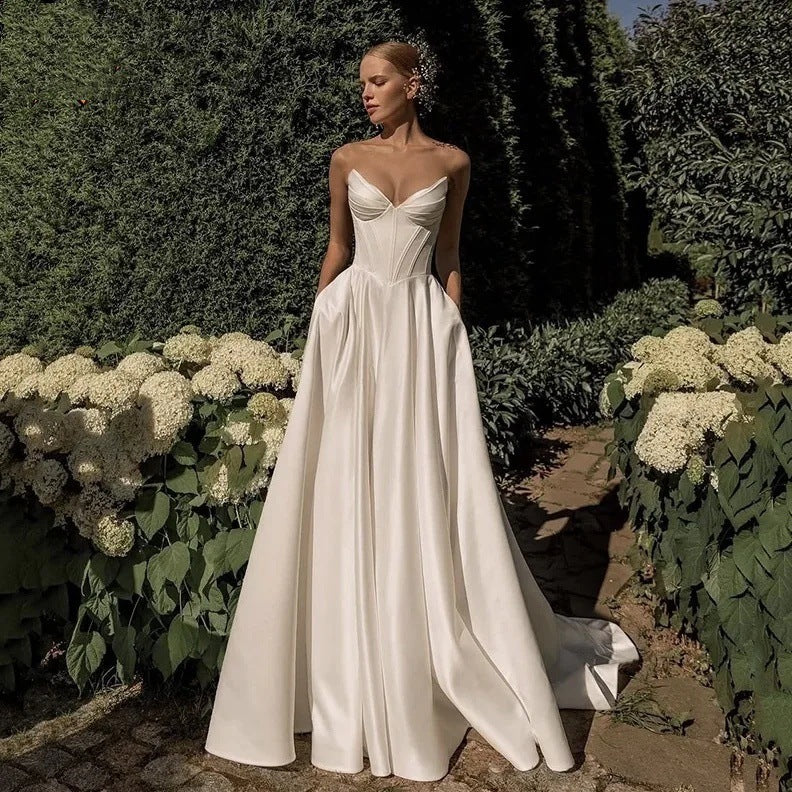 Sweetheart neckline of a strapless white satin bridal gown, close view