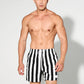 Man wearing striped swim trunks by the water in use