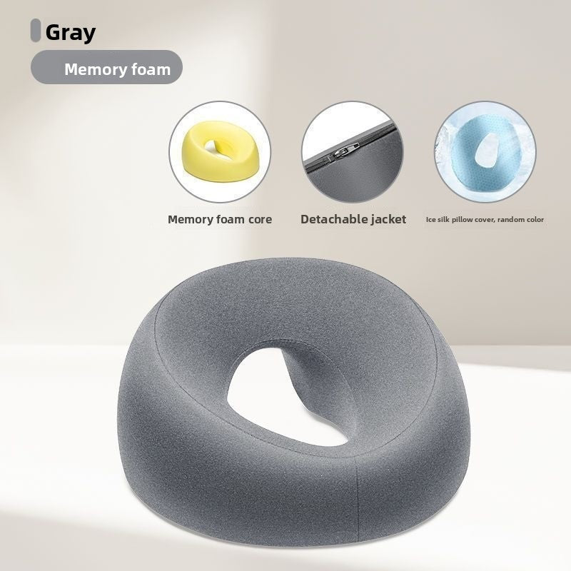 Gray memory foam face rest pillow shown with a cutaway of the yellow memory foam core and a zippered detachable jacket