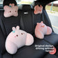 Pink rabbit headrest and lumbar pillows on a rear car seat beside a pink pig pillow pair