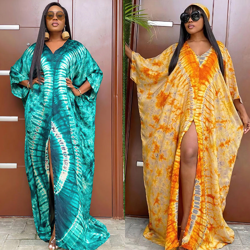 Side view of a tie dye kaftan maxi dress showing the high side slit and long batwing sleeve