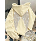Cream pullover hoodie with rhinestone wings on the back and a stone close-up, option photo for Cream 2XL