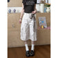 Black loose cargo pants showing wide cropped leg and matte washed fabric
