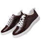 Burgundy crocodile embossed low-top sneakers with white laces and sole on a white background, size 43 option