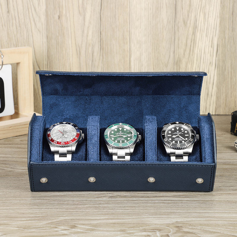 Watch roll open on a nightstand holding watches in padded slots