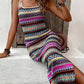 Purple and magenta tribal striped knit maxi dress seated, side slit open, front view