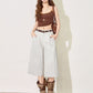 Light gray ice silk wide leg cropped trousers styled with tall boots