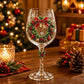 Clear wine goblet with a painted wreath and bells design on the glass bowl