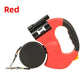 Red dual retractable pet leash with black grip pad, clip in torch and two reflective nylon webbing leads