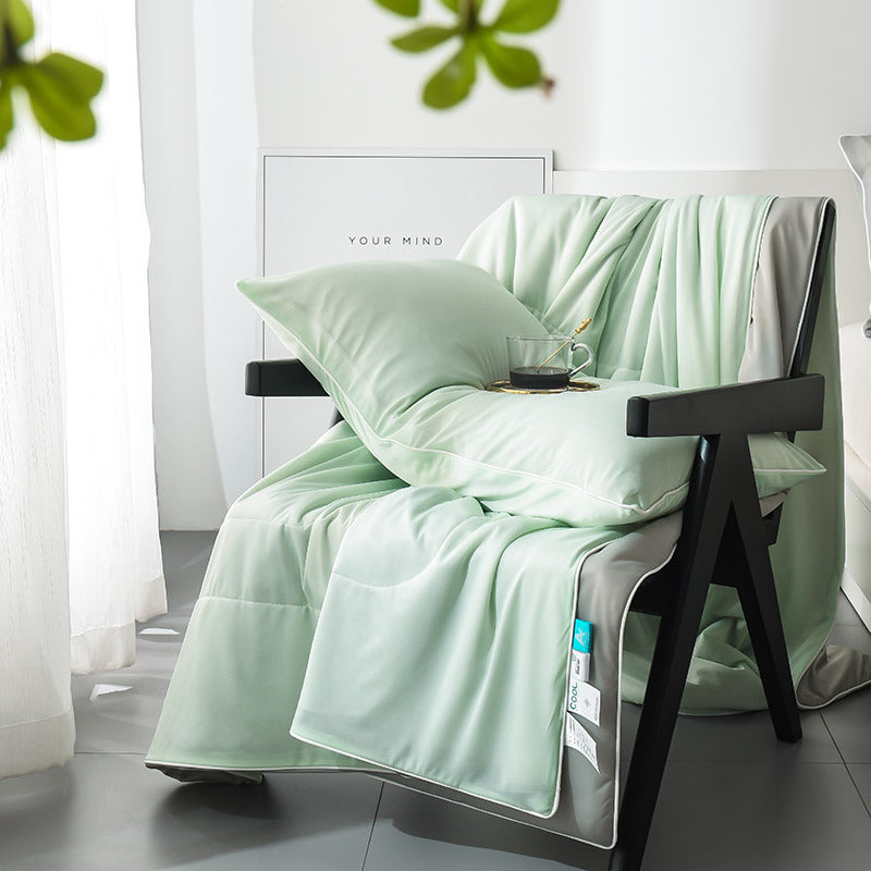 Box quilted polyester summer coverlet, face colour on top and pale putty grey on the reverse