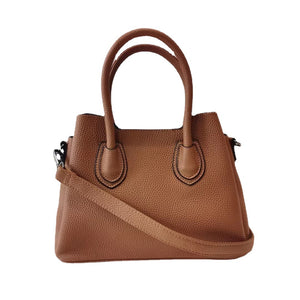 Top-layer cowhide bucket bag shown worn crossbody on model